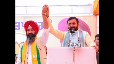 Haryana CM Nayab Singh Saini with BJP’s Tarn Tarn bypoll candidate Harjit Singh Sandhu on Friday. (HT Photo)