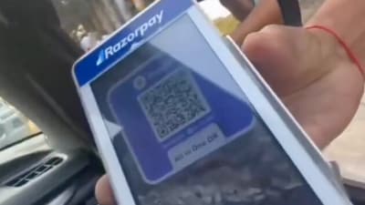 In the footage, the driver repeatedly asks the attendant why a Razorpay machine is displaying a PhonePe QR code. (X.com) In the footage, the driver repeatedly asks the attendant why a Razorpay machine is displaying a PhonePe QR code. (X.com)