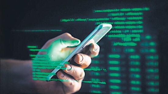 Darkweb, darknet and hacking concept. Hacker with cellphone. Man using dark web with smartphone. Mobile phone fraud, online scam and cyber security threat. Scammer using stolen cell. AR data code. (Shutterstock)