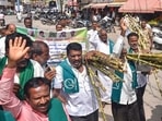 Farmers participate in a protest march demanding a fair price of  <span class='webrupee'>₹</span>3,500 per tonne for sugarcane, in Chikkamagaluru, Karnataka on Friday. (PTI)