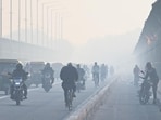 Vehicles moves through a thick layer of smog, at ITO Yamuna Bridge in New Delhi, on Friday.