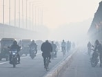Vehicles moves through a thick layer of smog, at ITO Yamuna Bridge in New Delhi, on Friday.