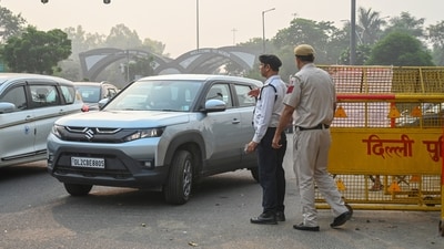 The incident took place around 5.30pm near the Tara Apartment crossing when flames suddenly erupted from the front portion of the vehicle as the woman waited for the light to turn green, her son seated beside her. (Sunil Gosh/Hindustan Times)