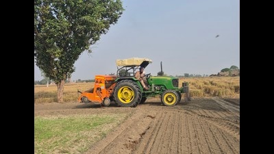 A farmer uses a super seeder to incorporate the crop residue back into the soil while simultaneously sowing seeds for the next crop. (HT Photo) A farmer uses a super seeder to incorporate the crop residue back into the soil while simultaneously sowing seeds for the next crop. (HT Photo)