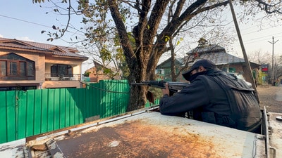 A security officer during a raid on the residence of an operative of Hizb-ul-Mujahideen, in Anantnag district on Saturday. (PTI) A security officer during a raid on the residence of an operative of Hizb-ul-Mujahideen, in Anantnag district on Saturday. (PTI)