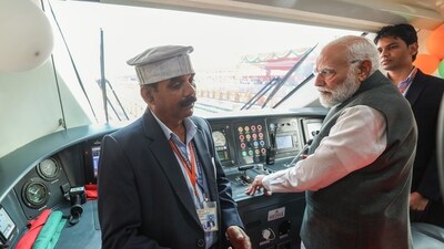 Prime Minister Narendra Modi interacts with railway officials in Vande Bharat coach after he flags off four new Vande Bharat Express trains, in Varanasi on Saturday.&nbsp; (DPR PMO)