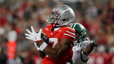 Wide receiver Carnell Tate #17 of the Ohio State Buckeyes catches a 49 yard pass for a touchdown (Getty Images via AFP) Wide receiver Carnell Tate #17 of the Ohio State Buckeyes catches a 49 yard pass for a touchdown (Getty Images via AFP)