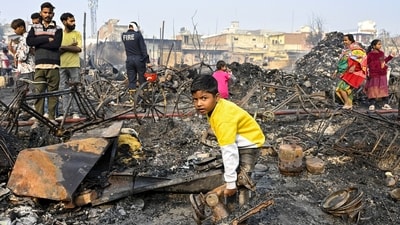 New Delhi: A child sifts through charred remains after a fire broke out spreading to around 500 shanties near Rithala metro station, at Rohini area, in New Delhi. (PTI) New Delhi: A child sifts through charred remains after a fire broke out spreading to around 500 shanties near Rithala metro station, at Rohini area, in New Delhi. (PTI)