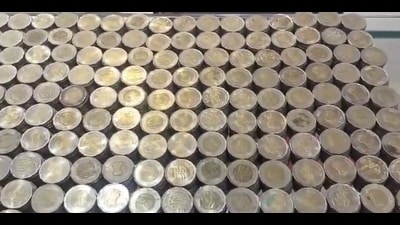 The coins that Abhishek Yadav, who runs a paan shop, saved for a year to buy a gold chain for his wife. (Sourced) The coins that Abhishek Yadav, who runs a paan shop, saved for a year to buy a gold chain for his wife. (Sourced)