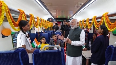 Prime Minister Narendra Modi interacts with school kids inside a coach of the Vande Bharat Express after flagging off four new train service (S Kumar/HT Photo)
