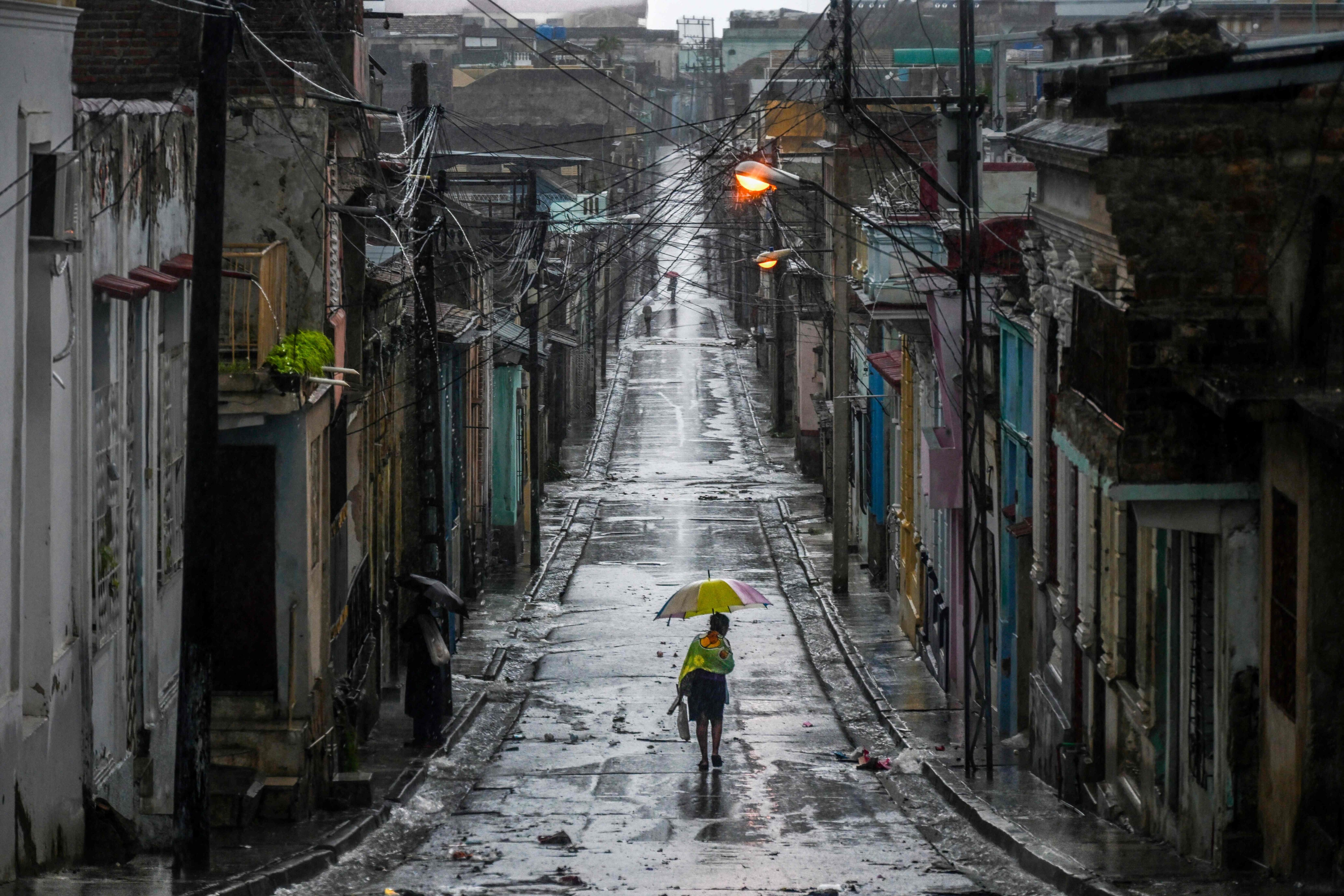 A woman walks down a deserted street ahead of Hurricane Melissa in Cuba, in October. (AFP) A woman walks down a deserted street ahead of Hurricane Melissa in Cuba, in October. (AFP)