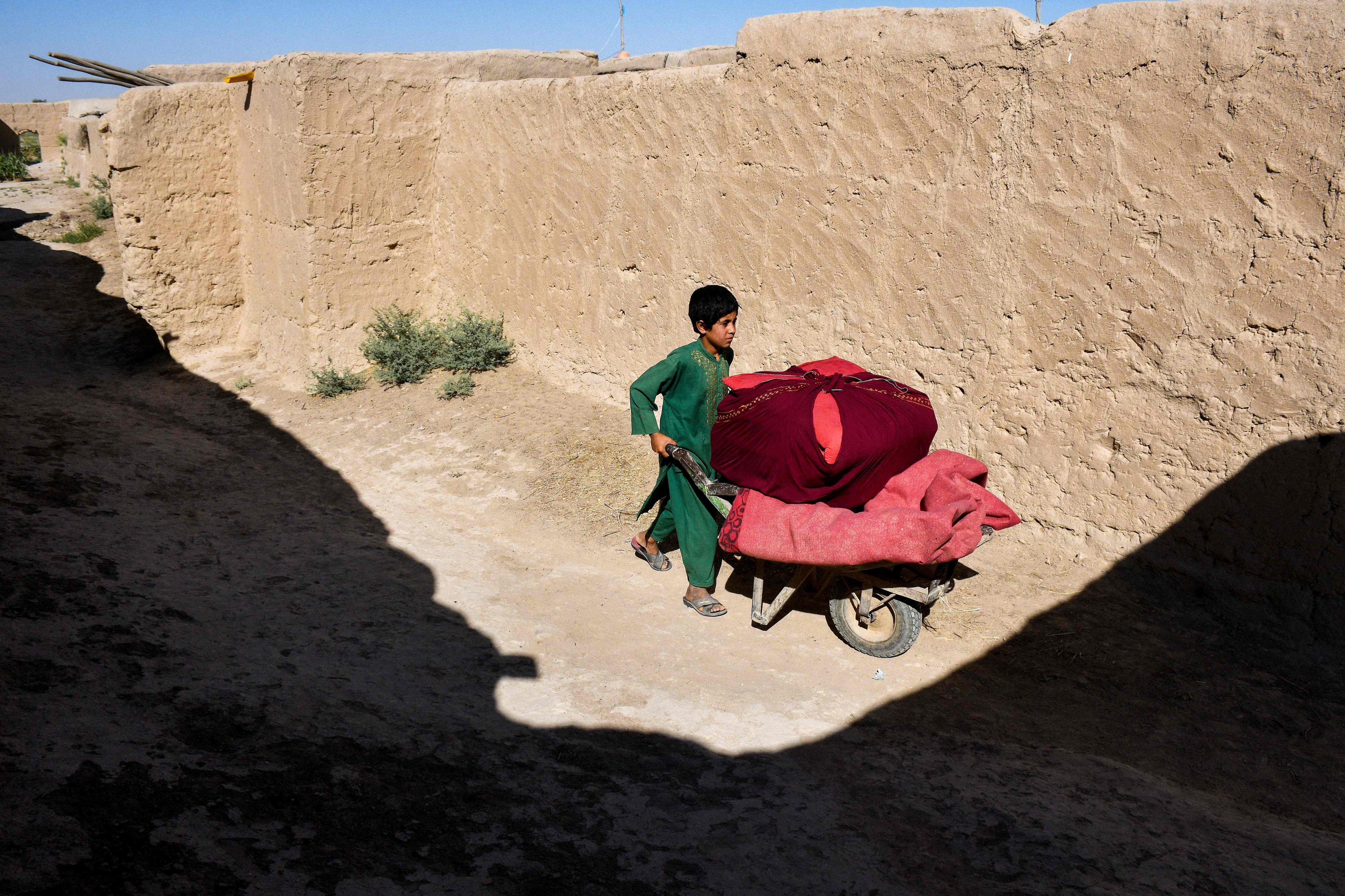 A child with a wheel-barrow along a deserted street in drought-ridden Balkh, Afghanistan, in July. (AFP) A child with a wheel-barrow along a deserted street in drought-ridden Balkh, Afghanistan, in July. (AFP)