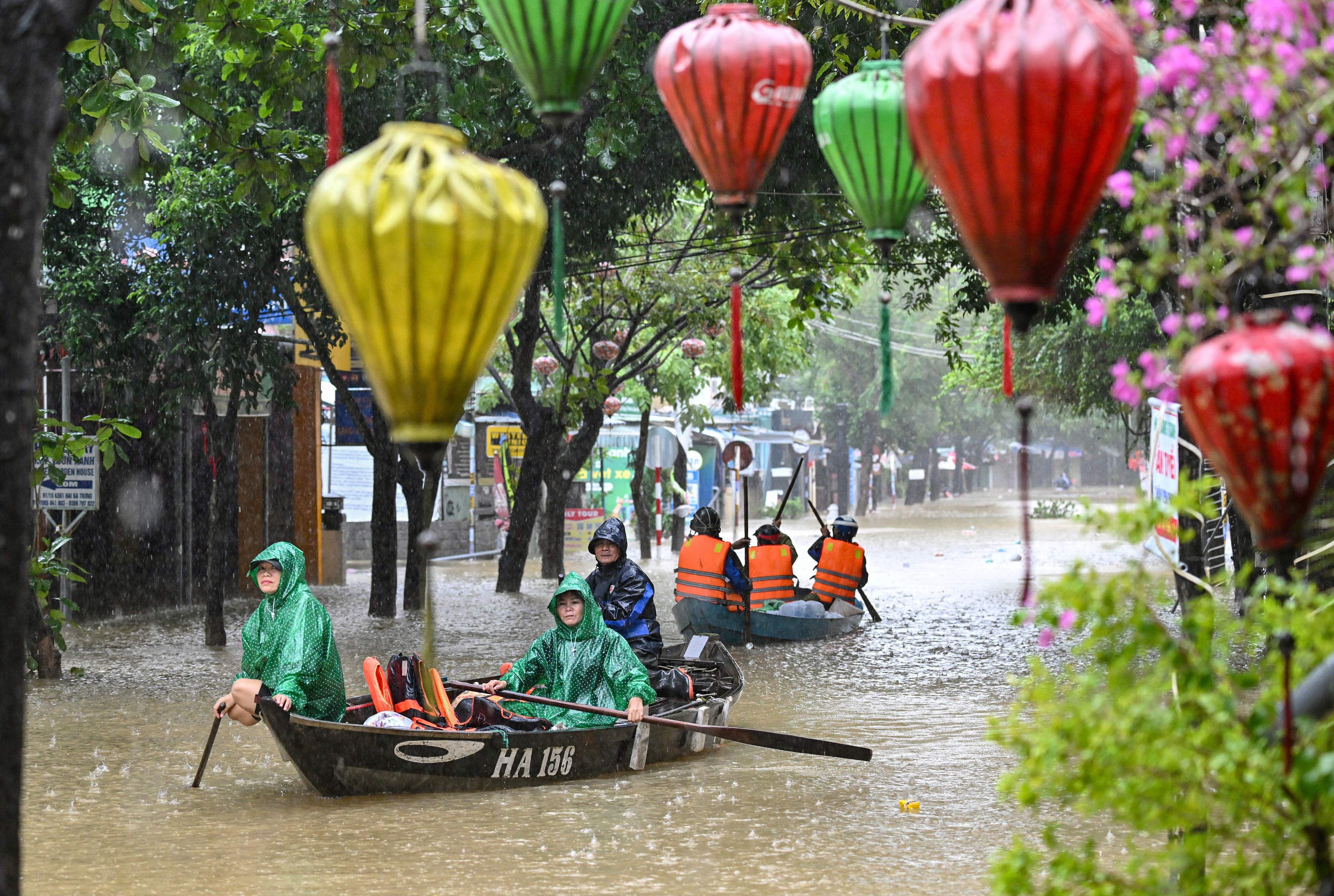 People navigate a flooded street in boats, in Hoi An, Vietnam, in October. (AFP) People navigate a flooded street in boats, in Hoi An, Vietnam, in October. (AFP)