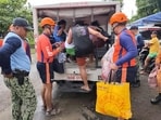 Irescuers evacuate people to safer grounds in Quezon province, eastern Philippines, as Typhoon Fung-wong enters the country on Sunday,