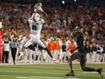 Cam Coleman #8 of the Auburn Tigers catches a pass in front of LeVar Thornton Jr. #25 of the Baylor Bears Cam Coleman #8 of the Auburn Tigers catches a pass in front of LeVar Thornton Jr. #25 of the Baylor Bears