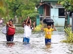 Residents evacuate from their flooded homes due to heavy rain brought by Typhoon Fung-wong in Remedios T. Romualdez, on the southern island of Mindanao on November 8, 2025. 