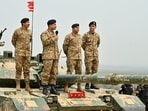 Chief of Army Staff of Pakistan Asim Munir holds a microphone during his visit at the Tilla Field Firing Ranges (TFFR) to witness an exercise Chief of Army Staff of Pakistan Asim Munir holds a microphone during his visit at the Tilla Field Firing Ranges (TFFR) to witness an exercise