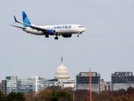 A United Airlines flight lands in front of the US Capitol at Ronald Reagan Washington National Airport