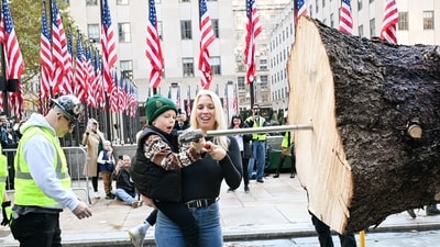 IMAGE DISTRIBUTED FOR TISHMAN SPEYER - Judy Russ with her son Liam, 7, help hammer a spike into the wrapped 75-foot tall, 11-ton Norway Spruce from East Greenbush, NY, that the Russ family donated to serve as the 2025 Rockefeller Center Christmas Tree, Saturday, Nov. 08, 2025, in New York. The Rockefeller Center Christmas Tree Lighting Ceremony will take place on Wednesday, Dec. 3. (Diane Bondareff/AP Content Services for Tishman Speyer) (AP) IMAGE DISTRIBUTED FOR TISHMAN SPEYER - Judy Russ with her son Liam, 7, help hammer a spike into the wrapped 75-foot tall, 11-ton Norway Spruce from East Greenbush, NY, that the Russ family donated to serve as the 2025 Rockefeller Center Christmas Tree, Saturday, Nov. 08, 2025, in New York. The Rockefeller Center Christmas Tree Lighting Ceremony will take place on Wednesday, Dec. 3. (Diane Bondareff/AP Content Services for Tishman Speyer) (AP)