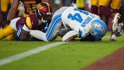 Detroit Lions wide receiver Amon-Ra St. Brown (14) scores during the first half of an NFL football game against the Washington Commanders (AP) Detroit Lions wide receiver Amon-Ra St. Brown (14) scores during the first half of an NFL football game against the Washington Commanders (AP)