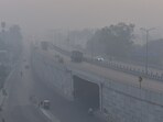 Vehicles move along National Highway 9 near Dasna amid low visibility caused by smog on Monday morning, a day after dense pollution blanketed the area, in the Delhi-NCR area..
