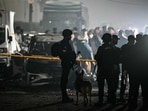 Police and security personnel stand at blast site in front of charred vehicles following an explosion near the Red Fort, in the old quarters of Delhi, on November 10, 2025. Police and security personnel stand at blast site in front of charred vehicles following an explosion near the Red Fort, in the old quarters of Delhi, on November 10, 2025.