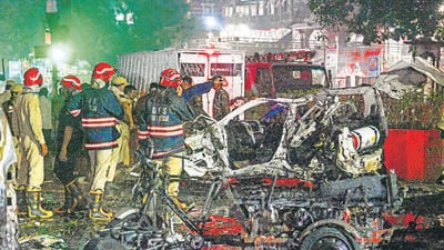 Delhi Fire Services officials douse the flames while police personnel take stock of the situation at the explosion site on Monday night. (Sanjeev Verma/HT Photo) Delhi Fire Services officials douse the flames while police personnel take stock of the situation at the explosion site on Monday night. (Sanjeev Verma/HT Photo)