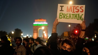 A person holds a banner during citizens protest against what they called the government's lack of action to combat air pollution in the capital city New Delhi, India, Sunday, Nov. 9, 2025.&nbsp; (AP)