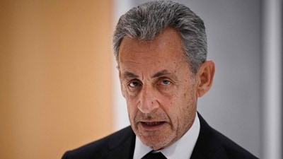 (FILES) Former French president Nicolas Sarkozy leaves after the verdict in his trial for illegal campaign financing from Libya for his successful 2007 presidential bid, at the Tribunal de Paris courthouse in Paris, on September 25, 2025. French prosecutors on November 10, 2025 requested the release from prison of former president Nicolas Sarkozy under judicial supervision pending an appeals trial over allegations that he sought Libyan funding. (Photo by JULIEN DE ROSA / AFP) (AFP)