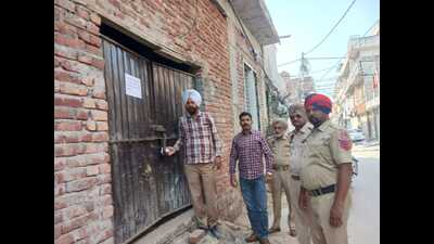 Officials sealing a house in Ludhiana on Monday. (HT Photo)