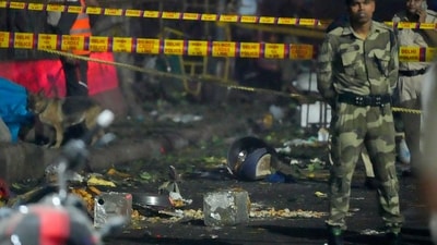 Tin containers and other items lie near the spot after a blast occurred in a parked car near Red Fort, leaving multiple vehicles in flames, in New Delhi, Monday (PTI) Tin containers and other items lie near the spot after a blast occurred in a parked car near Red Fort, leaving multiple vehicles in flames, in New Delhi, Monday (PTI)