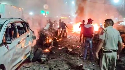 Fire department and police conduct rescue work amid the flames from vehicles after explosion near Delhi's Red Fort Metro station (PTI) Fire department and police conduct rescue work amid the flames from vehicles after explosion near Delhi's Red Fort Metro station (PTI)