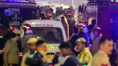 Emergency services personnel at the spot after a blast occurred in a parked car near Red Fort, in Delhi, Monday (PTI) Emergency services personnel at the spot after a blast occurred in a parked car near Red Fort, in Delhi, Monday (PTI)