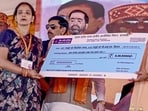 Chief minister Yogi Adityanath distributed cheques and certificates to beneficiaries of various schemes. (PTI) Chief minister Yogi Adityanath distributed cheques and certificates to beneficiaries of various schemes. (PTI)