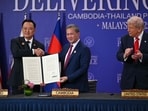 File photo of US President Donald Trump (R) looks on as Cambodia's Prime Minister Hun Manet (C) and Thailand's Prime Minister Anutin Charnvirakul hold up signed documents during a ceremonial signing of a ceasefire agreement last month. 