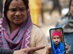 A family member of Jumman, an e-rickshaw driver who died in the blast near Red Fort, shows a picture of the deceased, in New Delhi, Tuesday, Nov. 11, 2025. 