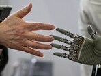 A man touches a robotic hand at the Global Developer Conference in Shanghai. Major Chinese tech companies are likely to spend $361 billion on AI this year through 2027, according to Bernstein analysts. A man touches a robotic hand at the Global Developer Conference in Shanghai. Major Chinese tech companies are likely to spend $361 billion on AI this year through 2027, according to Bernstein analysts.