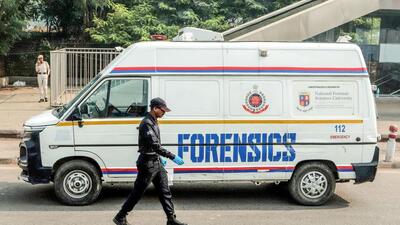 A National Security Guard personnel walks past a forensic van at the site of the Red Fort car blast, in New Delhi on Tuesday (ANI)