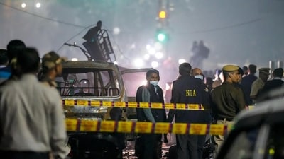 National Investigation Agency (NIA) team at the spot after a blast occurred in a parked car near Red Fort, leaving multiple vehicles in flames, in New Delhi, Monday. A high alert has been issued in NCR, Mumbai, Pune city after the incident that claimed eight lives. (PTI) National Investigation Agency (NIA) team at the spot after a blast occurred in a parked car near Red Fort, leaving multiple vehicles in flames, in New Delhi, Monday. A high alert has been issued in NCR, Mumbai, Pune city after the incident that claimed eight lives. (PTI)