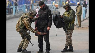 Paramilitary personnel frisking a pedestrian during a random search in Srinagar on Tuesday, a day after security was stepped up following a car blast in the national capital. (AFP Photo) Paramilitary personnel frisking a pedestrian during a random search in Srinagar on Tuesday, a day after security was stepped up following a car blast in the national capital. (AFP Photo)