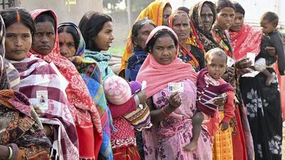People wait to cast their votes at a polling booth in Jehanabad, Bihar, on Tuesday. (PTI) People wait to cast their votes at a polling booth in Jehanabad, Bihar, on Tuesday. (PTI)