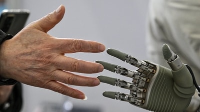 A man touches a robotic hand at the Global Developer Conference in Shanghai. Major Chinese tech companies are likely to spend $361 billion on AI this year through 2027, according to Bernstein analysts. A man touches a robotic hand at the Global Developer Conference in Shanghai. Major Chinese tech companies are likely to spend $361 billion on AI this year through 2027, according to Bernstein analysts.