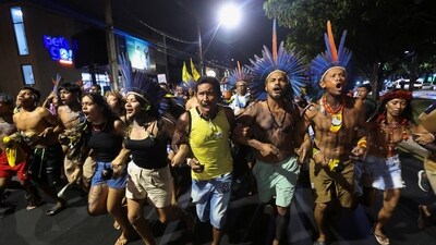Indigenous people walk together as they participate in a demonstration on the sidelines of the UN Climate Change Conference (COP30), in Belém, Brazil (REUTERS)