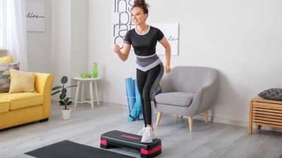 Step your way to fitness with compact, joint-friendly home workout steppers. (Adobe )