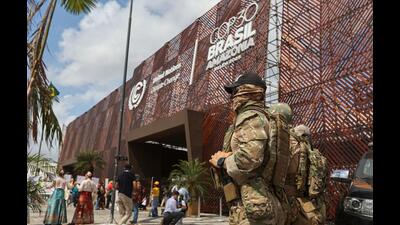 Police officers stand guard near the entrance of the venue hosting the UN Climate Change Conference, a day after Indigenous protesters stormed the entrance and clashed with guards while demanding climate action and protection for the Amazon forest, in Belem, Brazil, on Wednesday. (REUTERS) Police officers stand guard near the entrance of the venue hosting the UN Climate Change Conference, a day after Indigenous protesters stormed the entrance and clashed with guards while demanding climate action and protection for the Amazon forest, in Belem, Brazil, on Wednesday. (REUTERS)