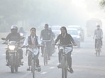Commuters out on a smoggy morning amid rising air pollution levels, in Noida, India, on Friday ,November 07, 2025. 