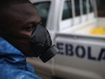 A health worker watches a burial team with Ebola victims in Liberia. (Getty File)