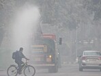 An anti-smog gun sprays water to curb air pollution, in Delhi, on Thursday. (PTI)