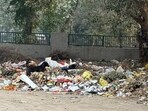 Garbage seen spread along the road in Sector 23A in Gurugram on Thursday. (HT Photo) Garbage seen spread along the road in Sector 23A in Gurugram on Thursday. (HT Photo)