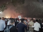 People gather near the Lal Qila metro station following a deadly explosion near the historic Red Fort in Delhi,